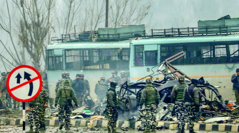 Security personnel carry out the rescue and relief works at the site of suicide bomb attack at Lathepora Awantipora in Pulwama district of Kashmir. (PTI)