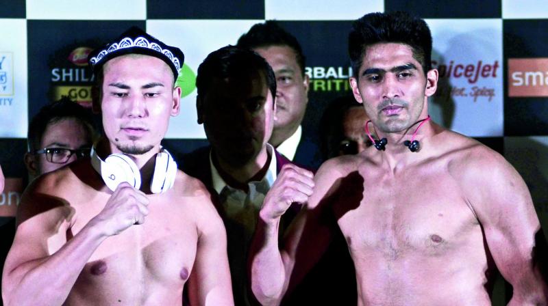 Zulpikar Maimaitiali (left) and Vijender Singh at the official weigh-in ceremony in Mumbai on Friday. (Photo: Shripad Naik)