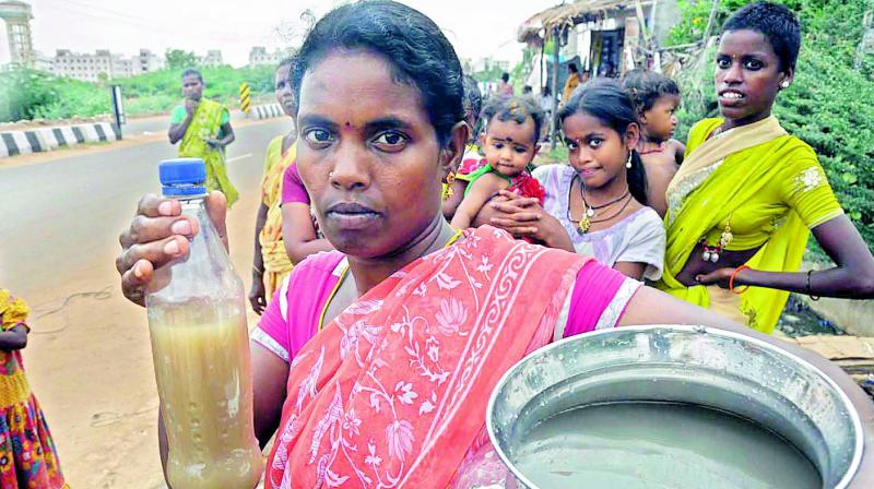 A woman shows the muddy water supplied by the civic authorities in Nellore city on Friday. (Photo: DC)