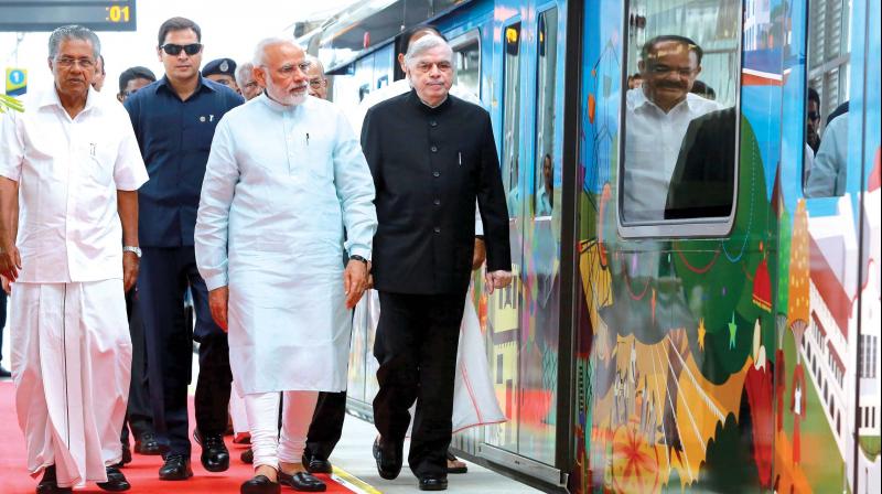 Chief Minister Pinarayi Vijayan, Prime Minster Narendra Modi and Governor P. Sathasivam come out after taking a ride on Kochi Metro on Saturday. (Photo: SUNOJ NINAN MATHEW)