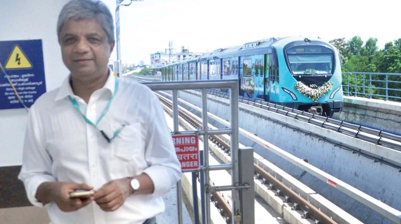 KMRL MD Elias George in front of a Kochi Metro train at CUSAT station. (Photo: Sunoj Ninan Mathew)