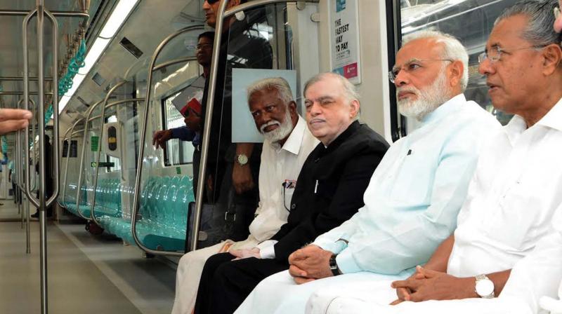 BJP state president Kummanam Rajasekharan takes a Metro ride along with Prime Minister Narendra Modi on Saturday. Chief Minister Pinarayi Vijayan and Governor P.Sathasivam look on.	(Photo: DC)