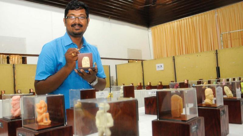 Artist Biju C.G. with his figurine sculptures made of soap at Museum auditorium in Thiruvananthapuram on Saturday. 	(Photo: DC)