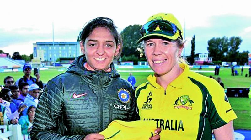 Australias Alex Blackwell (right) presents a jersey to Indias Harmanpreet after the World Cup semifinal on Thursday.
