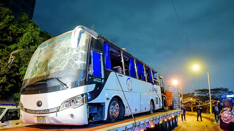 A tourist bus which was attacked being towed away in Giza province on Friday. Three Vietnamese holidaymakers and an Egyptian tour guide were killed when a roadside bomb blast hit their bus as it travelled close to the Giza pyramids outside Cairo. (AFP)