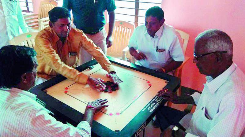 Senior citizens indulge in a game of carrom to unwind