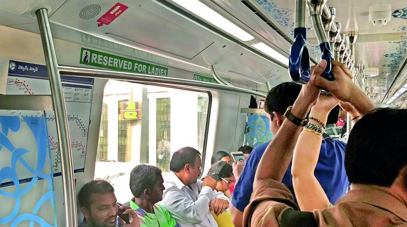 Men occupy ladies seats on Metro train near Nagole.