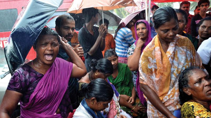 Fisherwomen weep after their dear ones have gone missing in the sea, at Poonthura in Thiruvanathapuram  on Friday. (Photo: Peethambaran Payyeri)