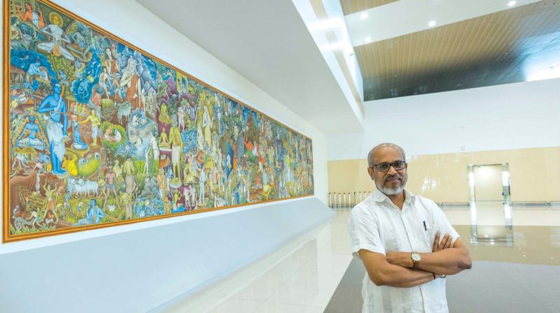 P.K. Sadanandan next to his mural painting.