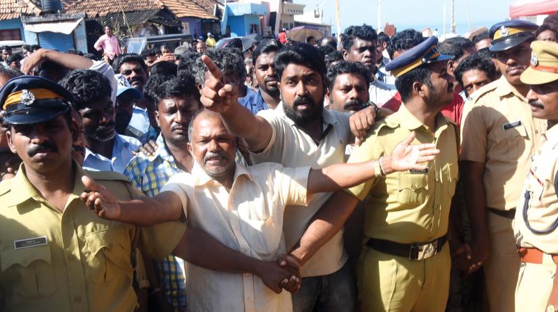 Angry protesters ask devaswom minister Kadakampally Surendran and fisheries minister J. Mercy Kutty Amma to go back during their visit to Poonthura.  (Photo:  DC)