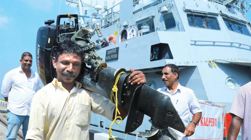 A fisherman rescued by Navy and brought to the Kochi shore in Navy ship INS Kalpeni comes out with the engine of his boat that got destroyed in the sea at Naval Base on Monday. Most fishermen are not willing to get into rescue boats leaving their boats and other belongings. (Photo: ARUNCHANDRA BOSE)