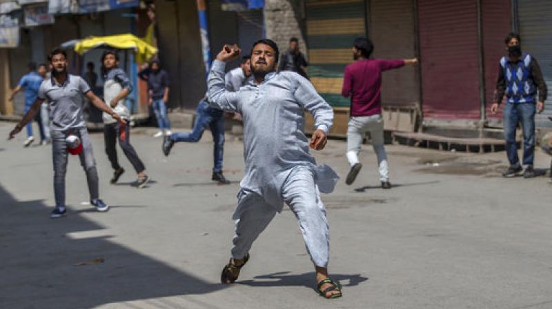 Kashmiri protesters throw bricks at Indian police during a protest in Srinagar. (Photo: AP)