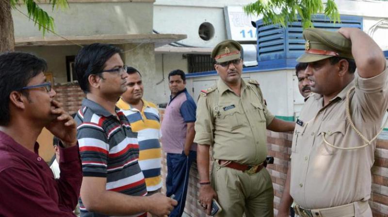 Family members of Karnataka Cadre IAS officer Anurag Tiwari wait outside a morgue to receive his body in Lucknow. (Photo: PTI)