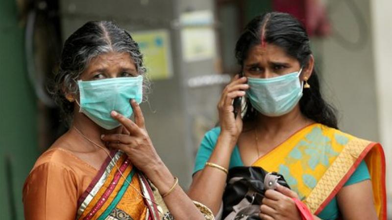 Family members of the patients admitted at the Kozhikode Medical College wear safety masks as a precautionary measure after the Nipah virus outbreak, in Kozhikode. (Photo: PTI)
