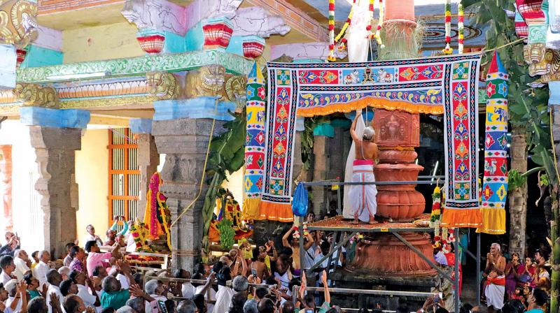 Flag hoisting being done by a priest to mark beginning of Masi Maham festival at Adhi Kumbeswaraswamy temple at Kumbakonam on Sunday.	DC