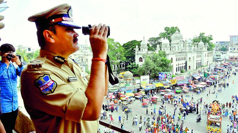 Hyderabad police commissioner Anjani Kumar watches the Ganesh procession from Charminar. (Image DC)