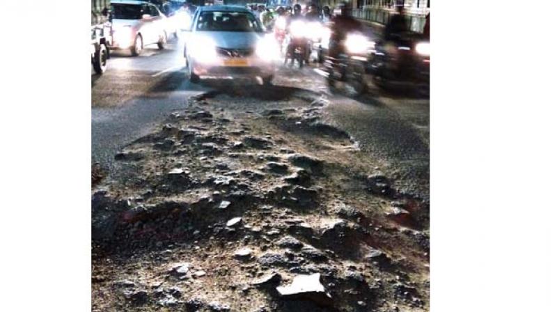 File photo of a huge pothole on Old Madras road near Swami Vivekananda Road Metro station (Image DC)