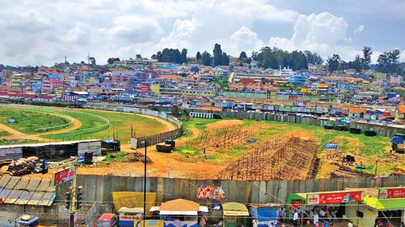 A piece of land at the eastern corner of the race course along ATC bus stop in Ooty is being considered forcreation of parking space. (Photo: DC)