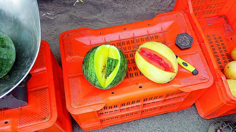 Green from the outside, but yellow on the inside watermelons on display at the Kushaiguda market