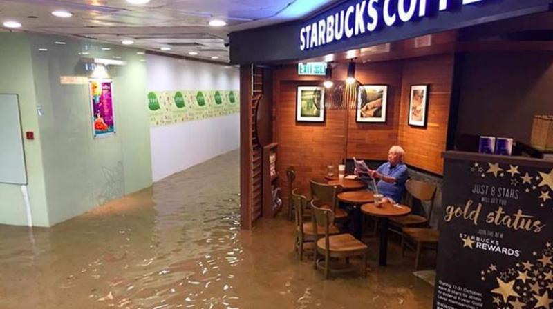 Man sits in cafe unfazed by floods, triggers epic Photoshop battle
