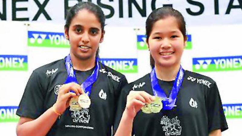 Jakka Vaishnavi Reddy (left) and Pattarsuda Chaiwan pose with their medals after winning the girls Under 16 doubles at the Yonex Rising Star badminton tournament in Bangkok in Thailand.