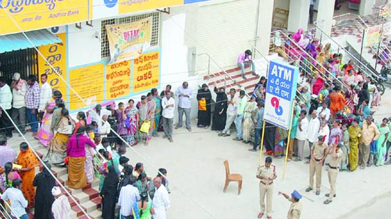 People wait in queue in front of a bank to withdraw cash at Georgepet in Anantapur on Tuesday. (Photo: DC)