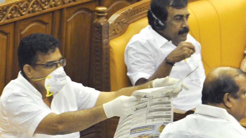 IUML MLA Parakkal Abdullah, representing Kuttiyadi constituency in Kozhikode, attends Assembly wearing a mask and gloves to convey his concern over Nipa virus scare, on Monday. (Photo: A.V. Muzafar )