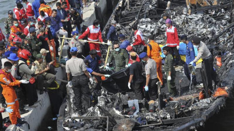 Rescuers search for victims from the wreckage of a ferry that caught fire off the coast of Jakarta after it was docked at Muara Angke Port in Jakarta. (Photo: AP)