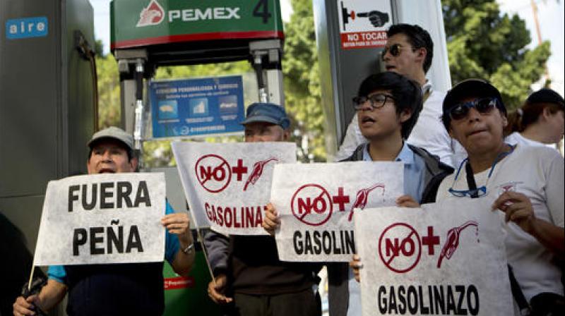 The government plans to end subsidies and let the market dictate prices in March. But Mexicans will feel the pinch at the pump before they start falling. (Photo: AP)