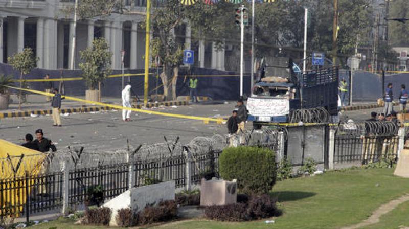 Pakistani investigators work at the site of a deadly bomb blast on Monday, in Lahore, Pakistan. (Photo: AP)