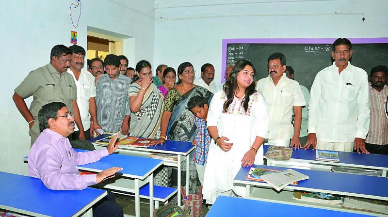 Urban development minister P. Narayana inspects the new furniture in a municipal school at Nellore on Tuesday. Nellore Corporation chief S. Dilli Rao is seen explaining about the infrastructure to the minister. (Photo: DC)
