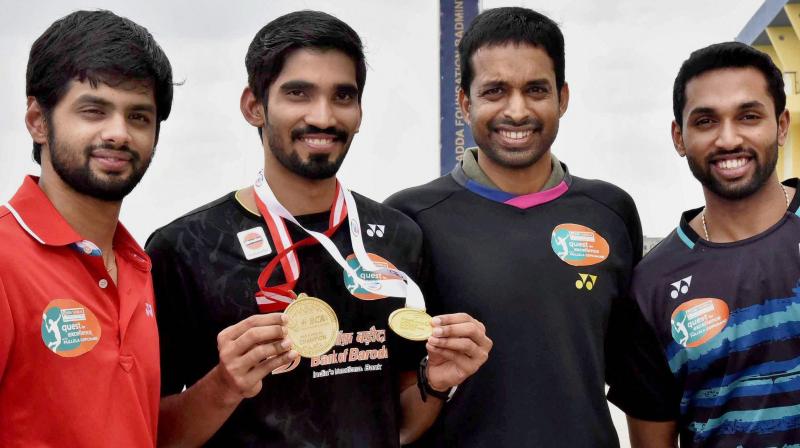 Shuttlers Kidambi Srikanth, B Sai Praneeth, H S Prannoy along with Chief National Coach P Gopichand were today felicitated by Telangana Governor ESL Narasimhan here.(Photo: AP)