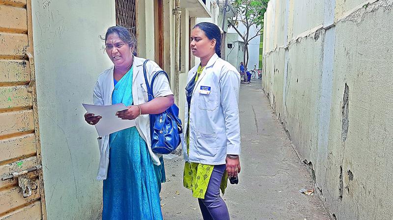 Health workers on duty await families to respond as they refused to open doors.