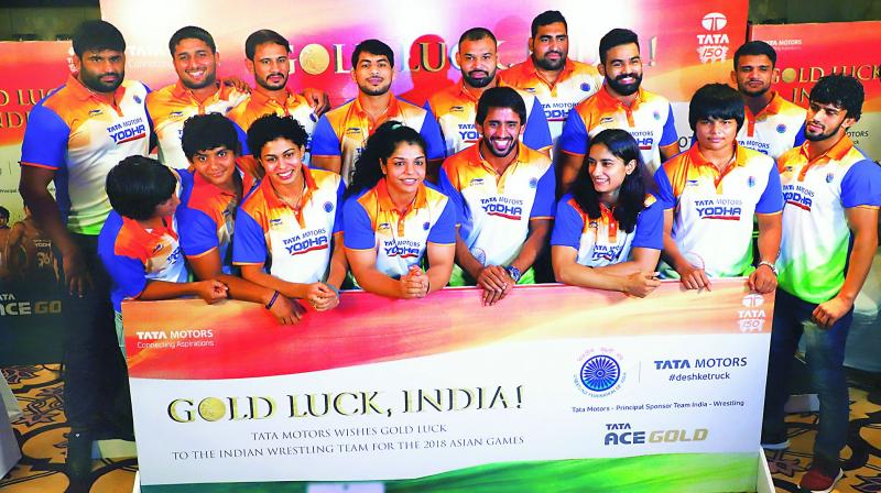Asiad-bound Indian wrestlers pose at an event in New Delhi on Sunday.