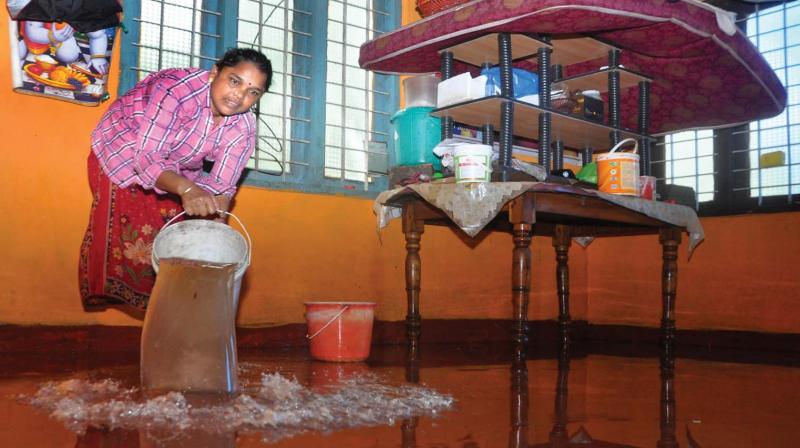 Lakshmi, a native of Edamula in Eloor, is busy cleaning her house after water receded on Sunday. (Photo: UNOJ NINAN MATHEW)