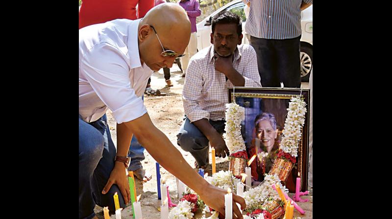 Gauri Lankeshs brother Indrajit lights a candle in Chamarajpet on Monday. (Photo: DC)