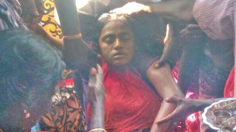 Villagers grieve over the death of Anitha. (Photo:DC)