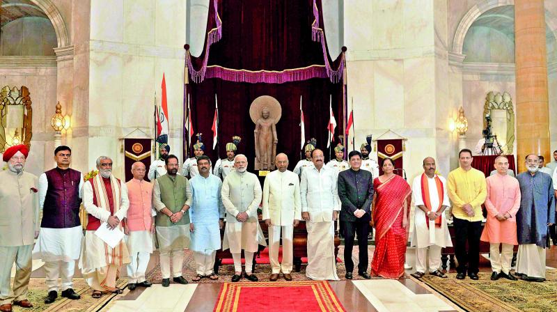 President Ram Nath Kovind, Vice-President M. Venkaiah Naidu, Prime Minister Narendra Modi poses with new inducted members of the Union Council of Ministers at Rashtrapati Bhavan in New Delhi on Sunday. (Photo: PTI)