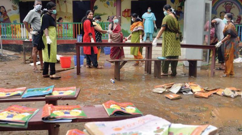 Teachers clean a flood-hit school in Eloor, Ernakulam. (File pic)