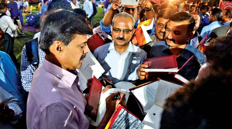 Former STF chief K Vijay Kumar autographs his book  during a launch function in Chennai on Friday. (Photo: DC)