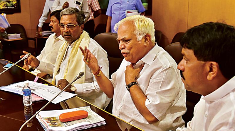 Chief Minister Siddaramaiah and Major Industries Minister R.V. Deshpande at an Industries department review meeting at Vidhana Soudha in Bengaluru on Wednesday.