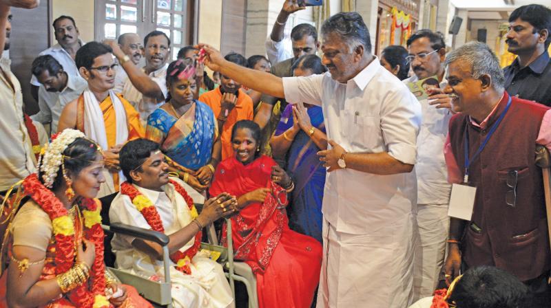 Deputy Cheif Minister O. Panneerselvam blesses a newly married couple at mass wedding event for disabled persons organised by Shree Geetha Bhavan Trust, on Monday. (Photo: DC)