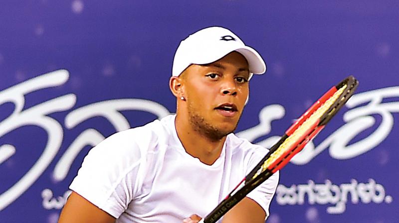 Briton Jay Clarke plays a return in his victory over Ramkumar Ramanathan at the KSLTA courts in Bengaluru on Wednesday. (Photo: SHASHIDHAR B)