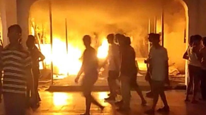 Students set fire to properties on the campus hostel at Sathyabama University on Wednesday (Photo: DC)