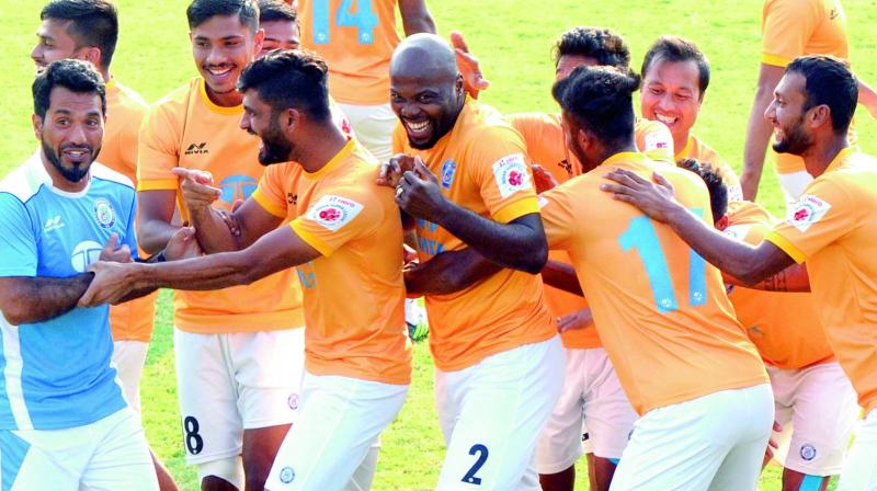 Jamshedpur FC players share a light moment with assistant coach Ishfaq Ahmed (left) at a training session in Kochi on Thursday. (Photo:  ARUN CHANDRABOSE)
