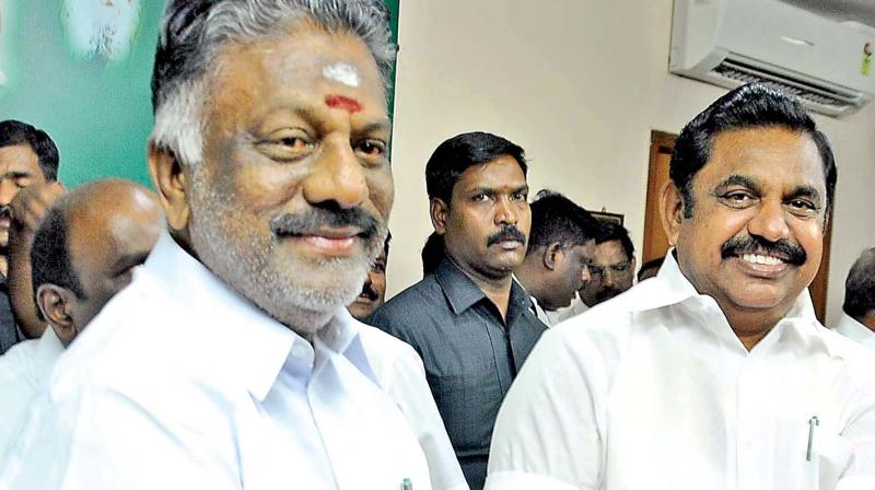 Tamil Nadu Chief Minister Edappadi K. Palaniswami greets Deputy Chief Minister O. Panneerselvam at AIADMK party office after Election Commission allotted the partys Two Leaves symbol to them on Thursday (Photo: DC)
