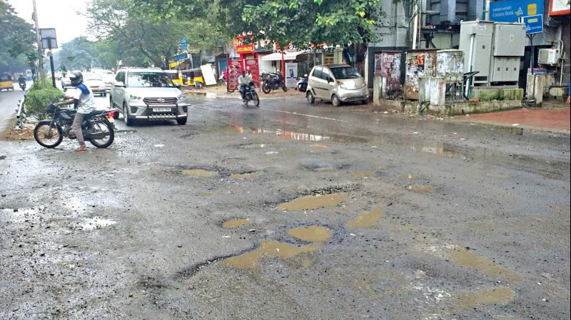 Unattended Anna main road in K.K. Nagar filled with  potholes. (Photo: DC)