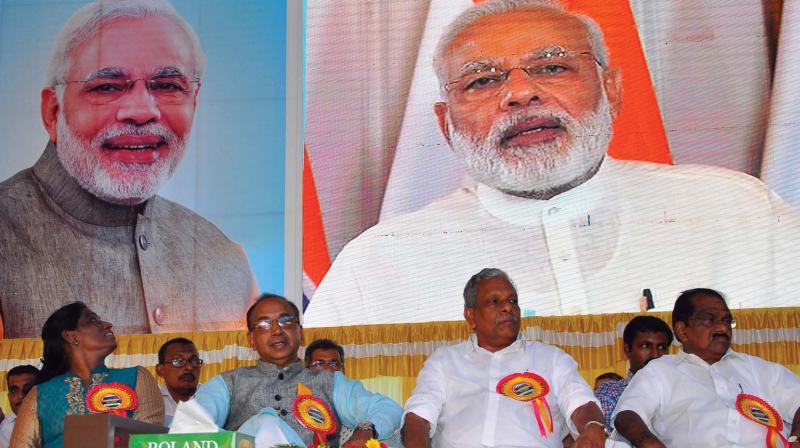 P.T. Usha looks at the screen while Prime Minister Narendra Modi delivers the inaugural speech at Kinalur in Kozhikode on Thursday. (Photo: VISWAJITH K.)