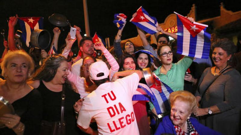 The Cuban community celebrates the announcement that Fidel Castro died as they gather in front La Carreta Restaurant early Saturday in Miami. (Photo: AP)