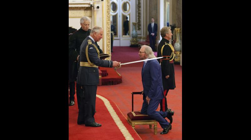 Singer and songwriter Barry Gibb is knighted by Britains Prince Charles, during an Investiture ceremony at Buckingham Palace in London, Tuesday June 26, 2018. (Photo: AP)